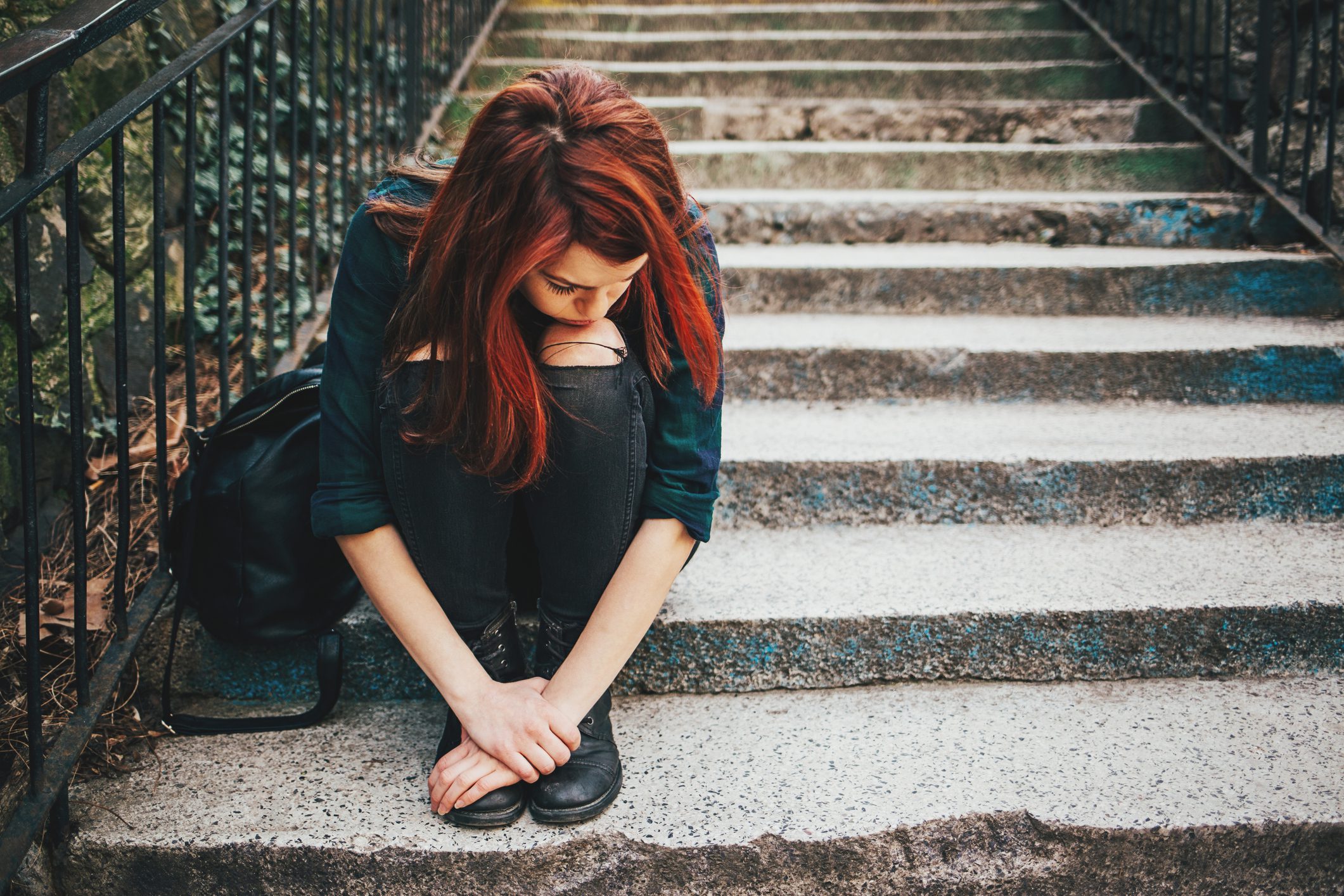 Sad woman on the steps.
