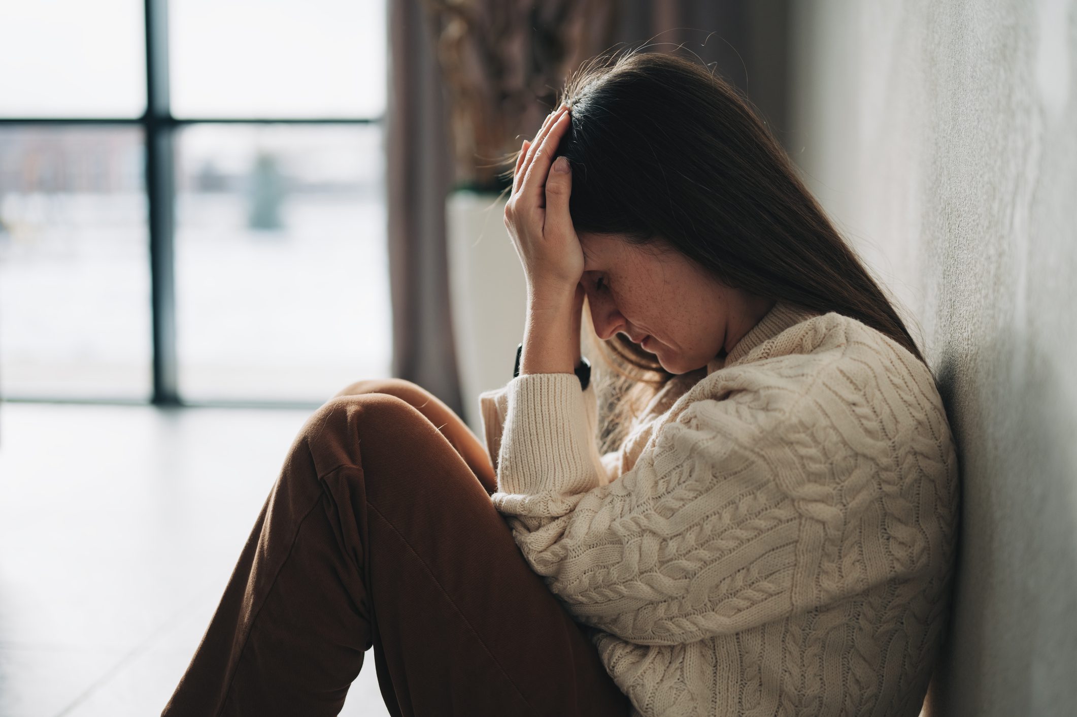 Woman sad and sitting down.